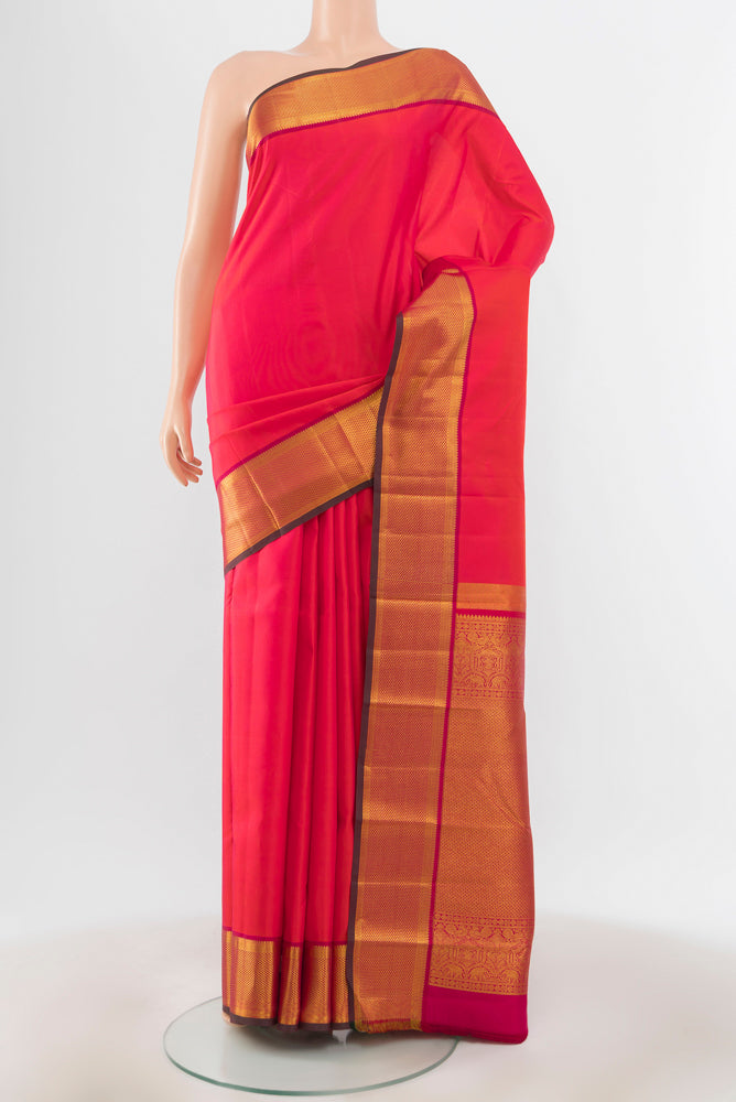 Peach Kanchipuram Silk Saree with Zari Brocade on the body and Silk Border.  displayed on a mannequin