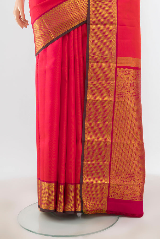 Pleats and pallu of Peach Kanchipuram Silk Saree with Zari Brocade on the body and Silk Border. 