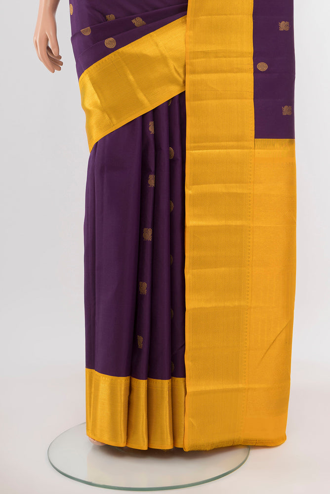 Pleats and pallu of Purple Kanchipuram Silk Saree with Zari Butta on the body and Silk Border. 