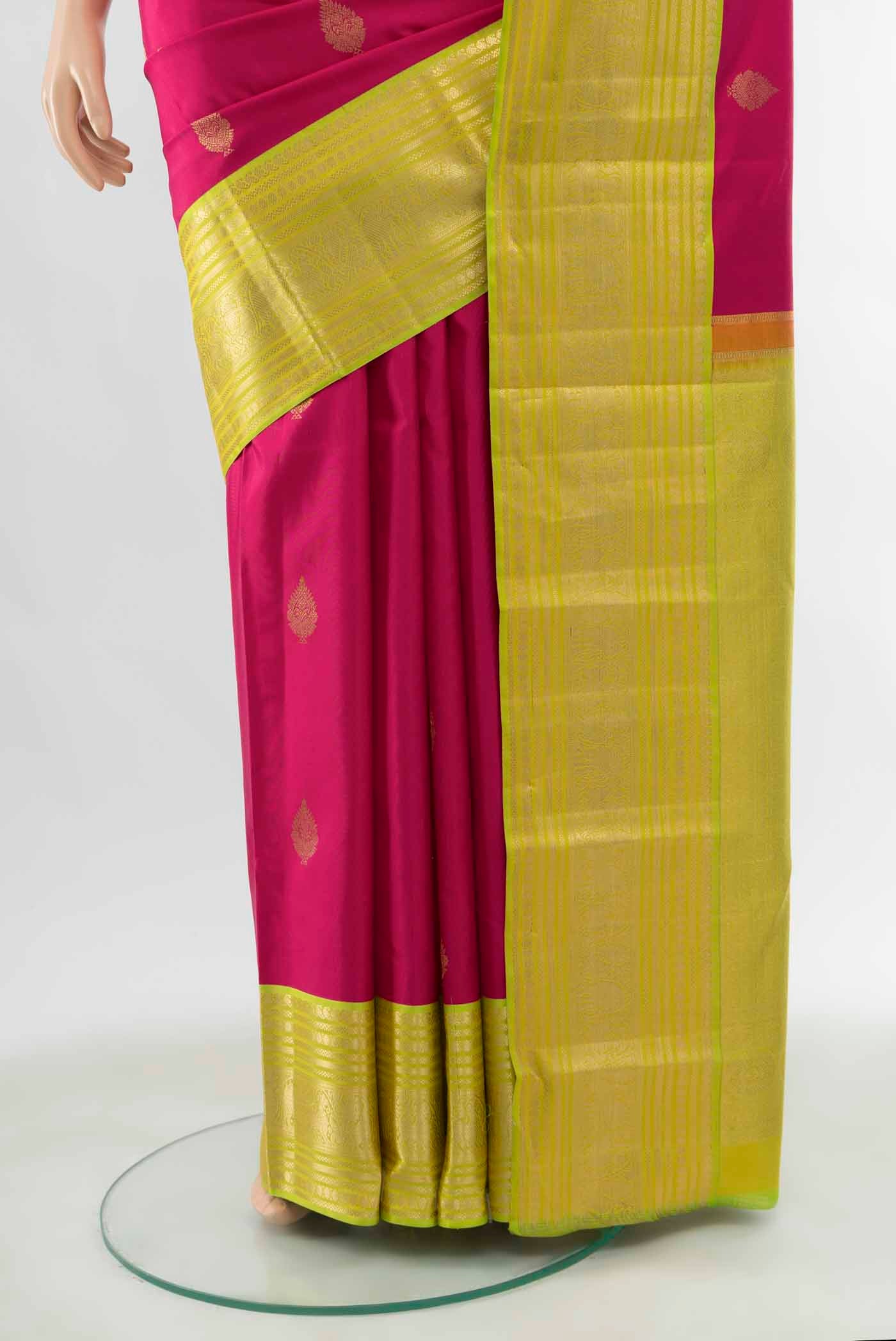 Pleats and pallu of Dark Pink Kanchipuram Silk Saree with Zari Butta on the body and Silk Border