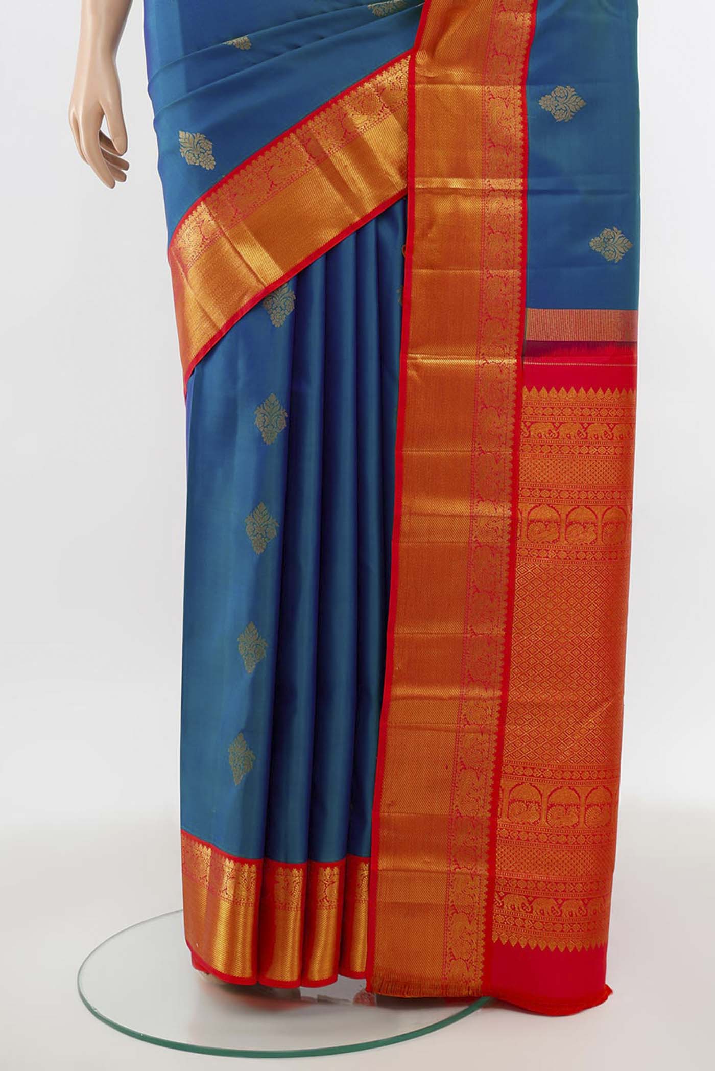 Pleats and pallu of Peacock Blue Kanchipuram Silk Saree with Zari Butta on the body and Silk Border. 