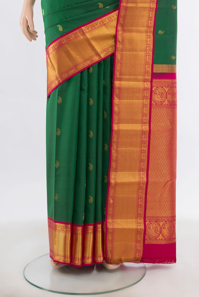 Pleats and pallu of Bottle Green Kanchipuram Silk Saree with Zari Butta on the body and Silk Border. 