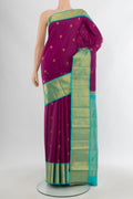 Purple Kanjivaram Silk Saree with Zari Butta on the body and Zari Border.  displayed on a mannequin