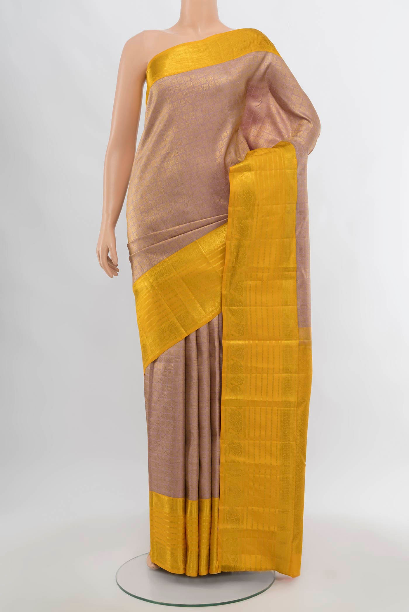 Golden Kanjivaram Silk Saree with Zari Butta on the body and Silk Border.  displayed on a mannequin