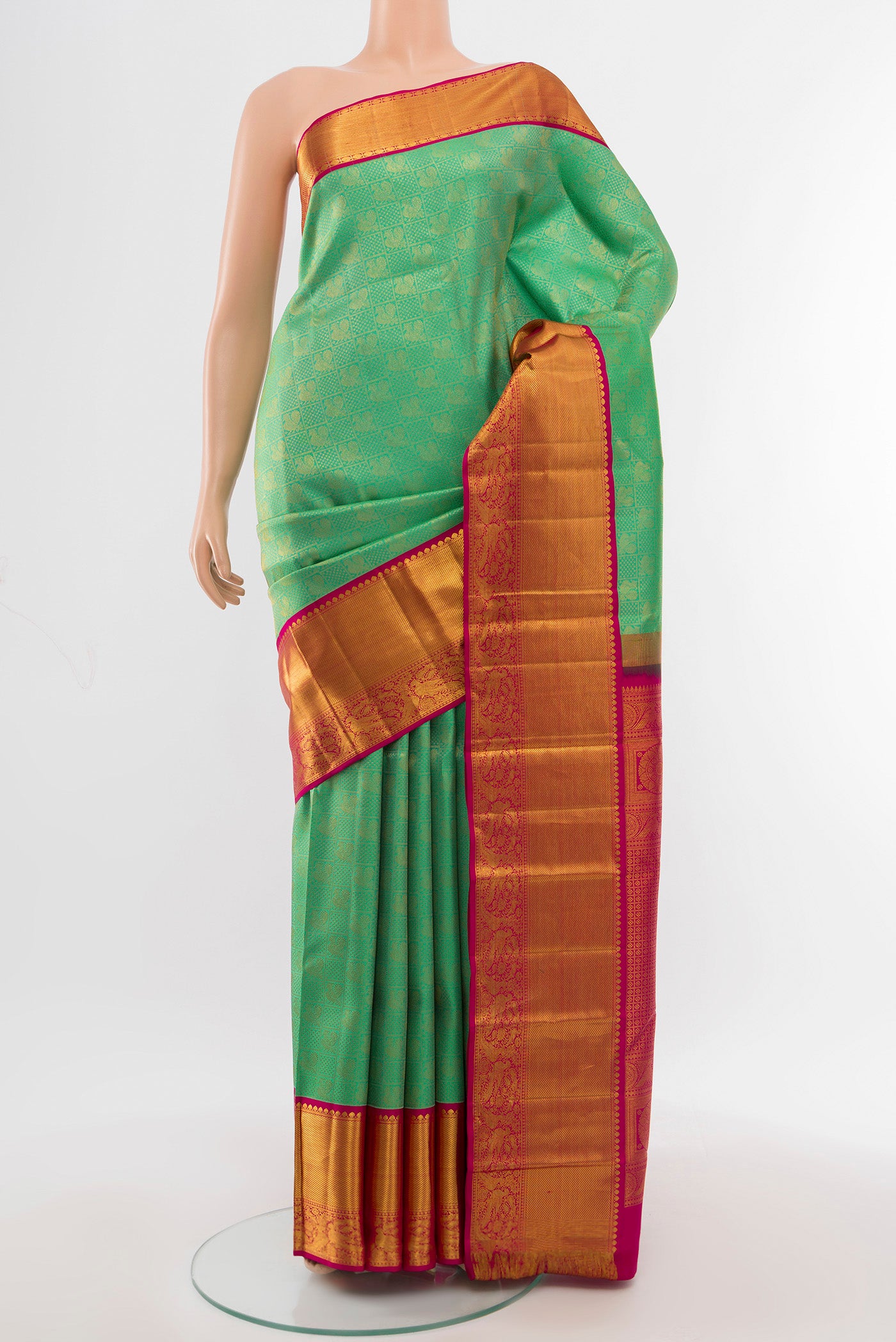 Pure Silk Pure Zari Light Green Kanjivaram Saree with Zari Butta on the body and Silk Border.  displayed on a mannequin