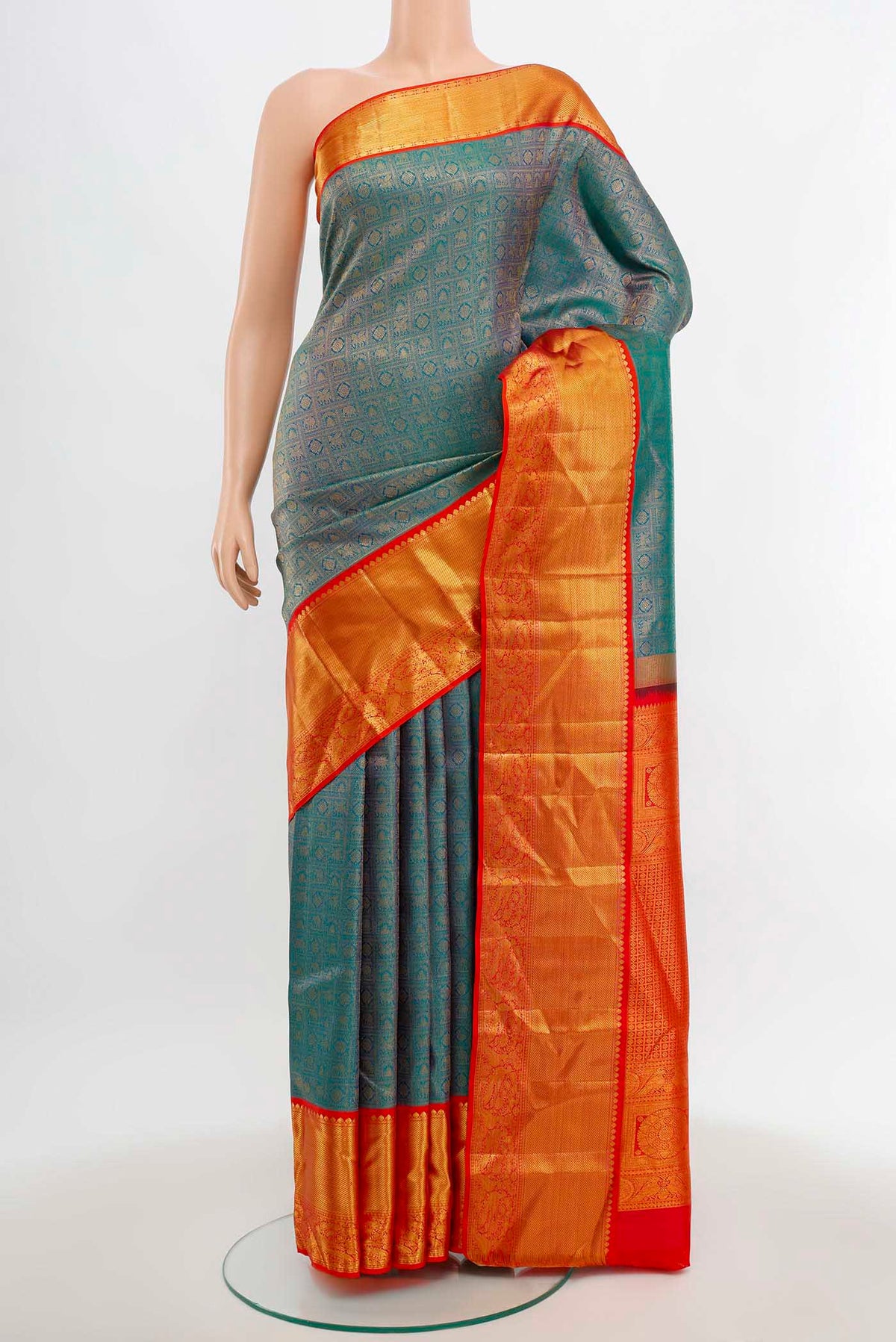 Peacock Blue Kanjivaram Silk Saree with Zari Butta on the body and Silk Border.  displayed on a mannequin