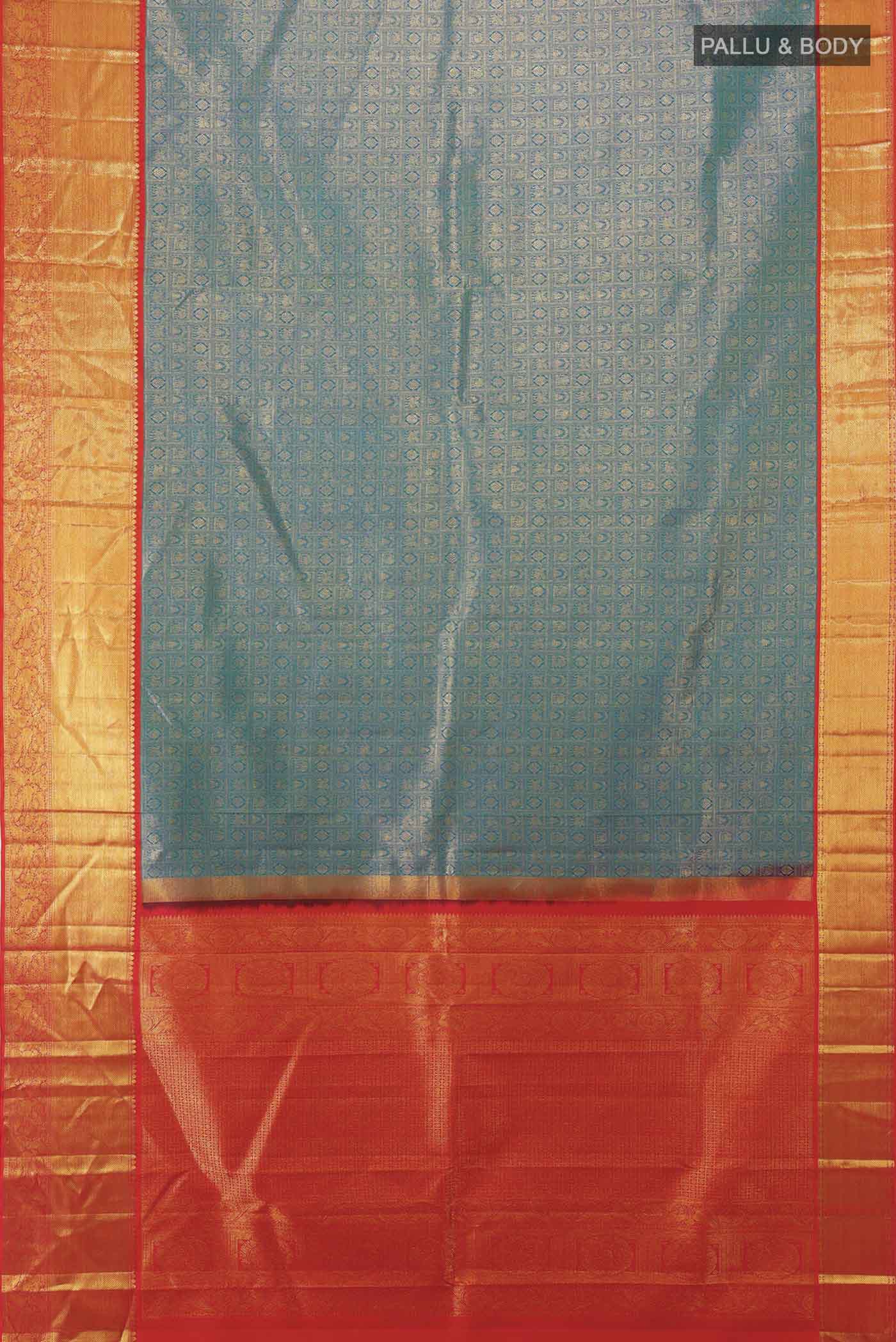 Flat view of Peacock Blue Kanjivaram Silk Saree with Zari Butta on the body and Silk Border. 