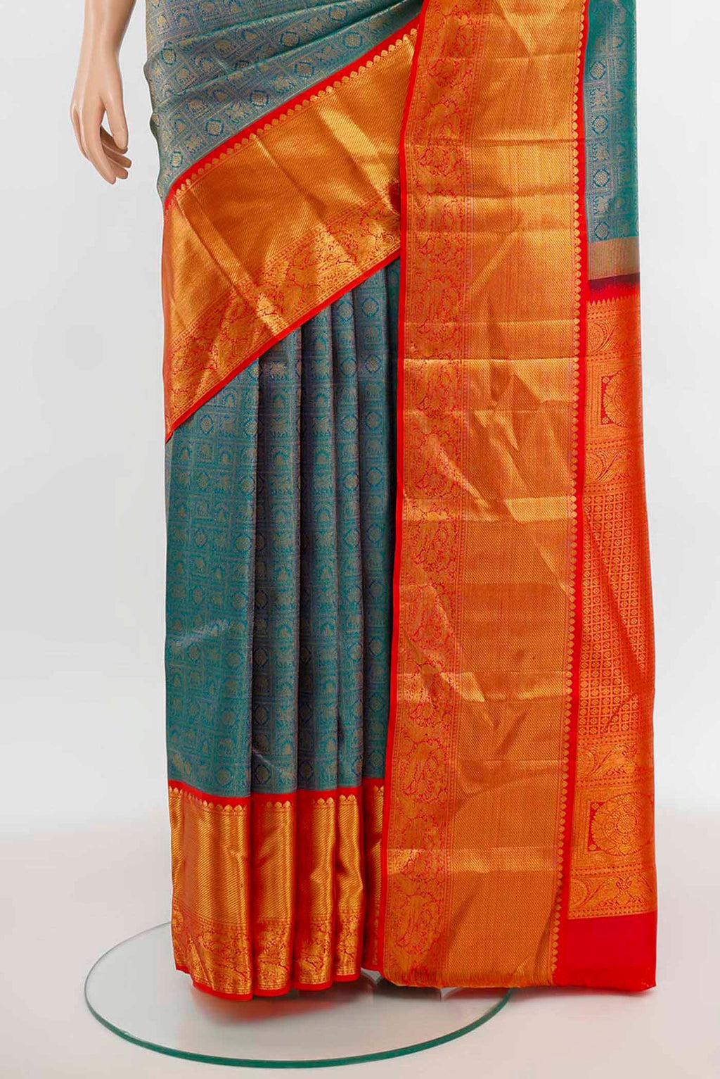 Pleats and pallu of Peacock Blue Kanjivaram Silk Saree with Zari Butta on the body and Silk Border. 