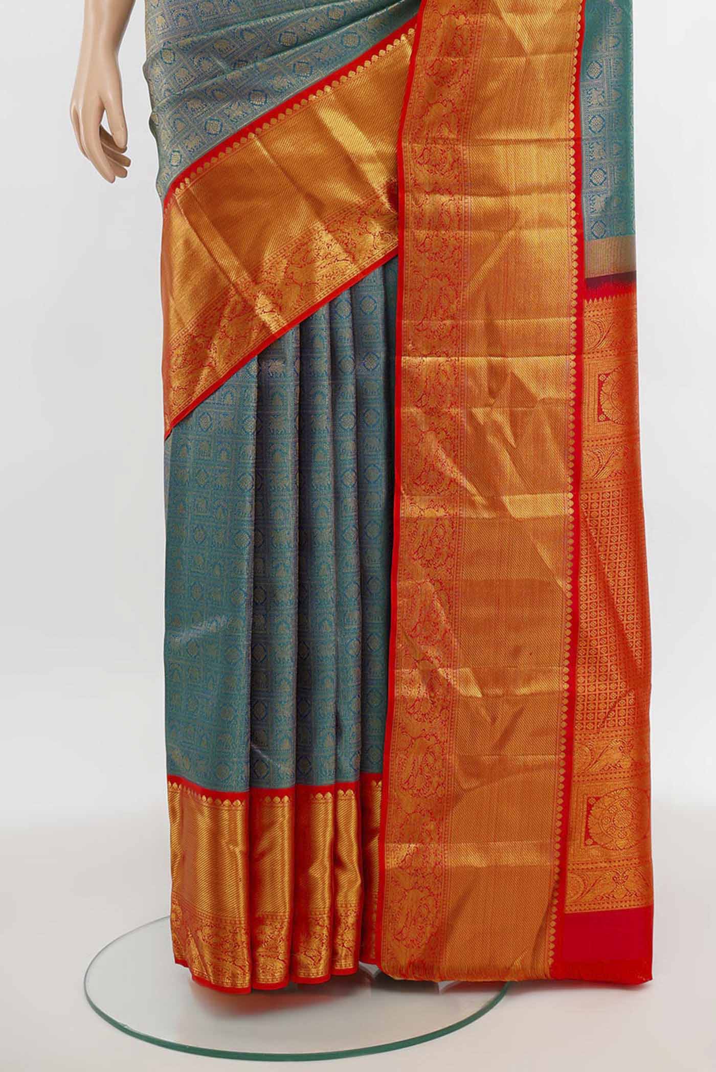 Pleats and pallu of Peacock Blue Kanjivaram Silk Saree with Zari Butta on the body and Silk Border. 