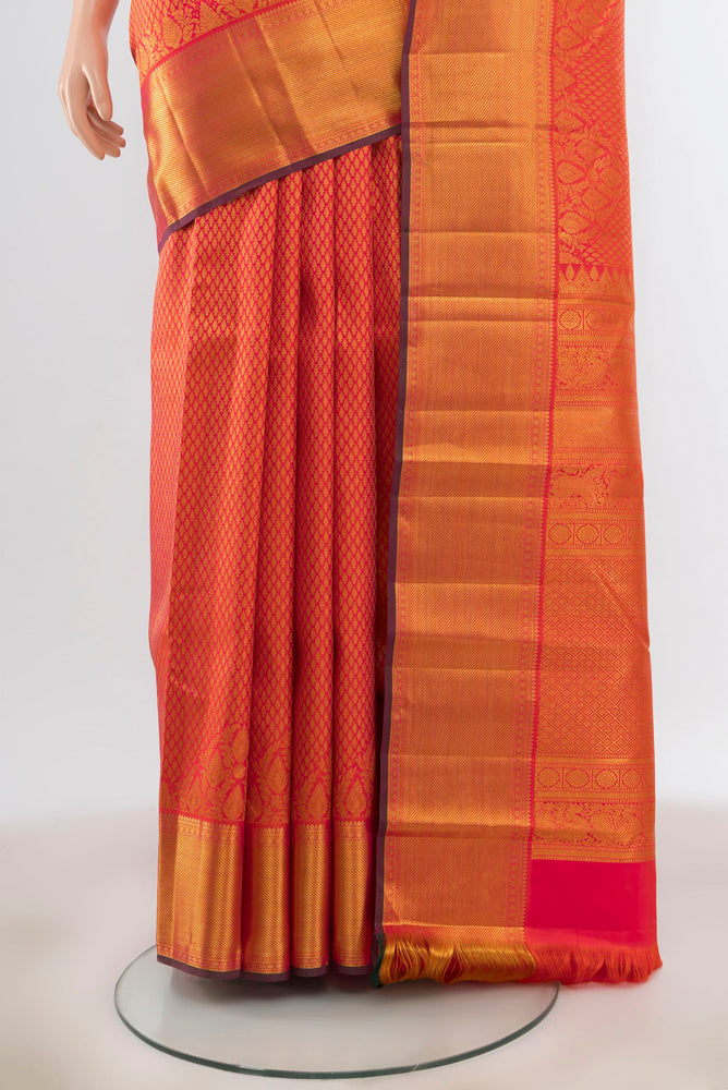 Pleats and pallu of Peach Kanjivaram Silk Saree with Zari Butta on the body and Silk Border. 