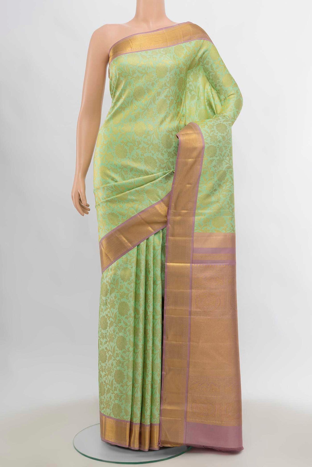 Pista Green Kanchipuram Silk Saree with Zari Brocade on the body and Zari Border displayed on a mannequin
