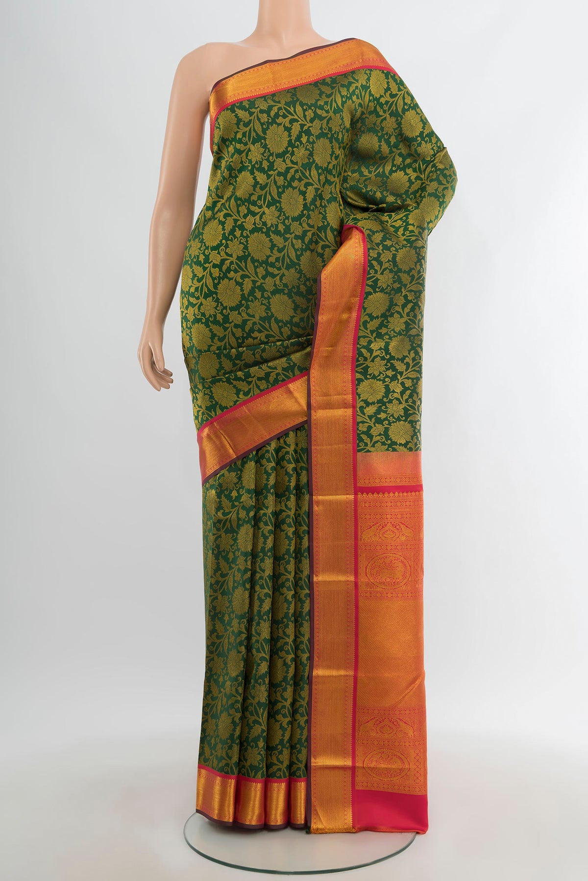Bottle Green Kanjivaram Silk Saree with Zari Brocade on the body and Zari Border.  displayed on a mannequin