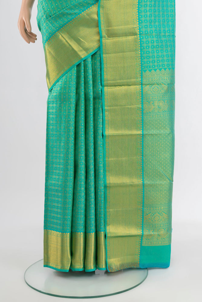 Pleats and pallu of Light Green Kanjivaram Silk Saree with Zari Butta on the body and Silk Border. 