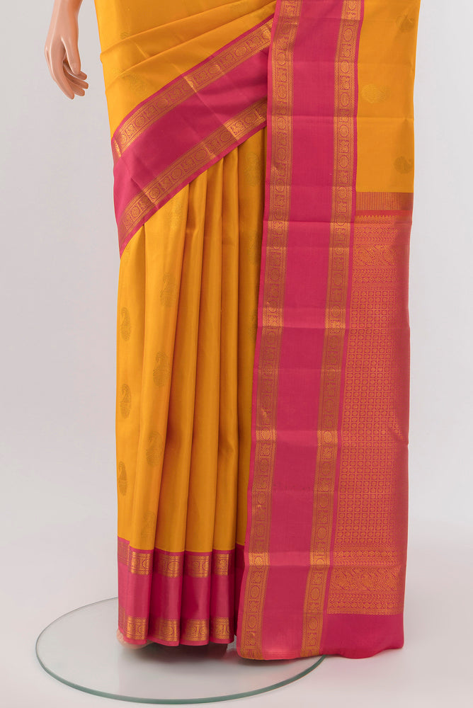 Pleats and pallu of Yellow Kanchipuram Silk Saree with Zari Butta on the body and Silk Border. 