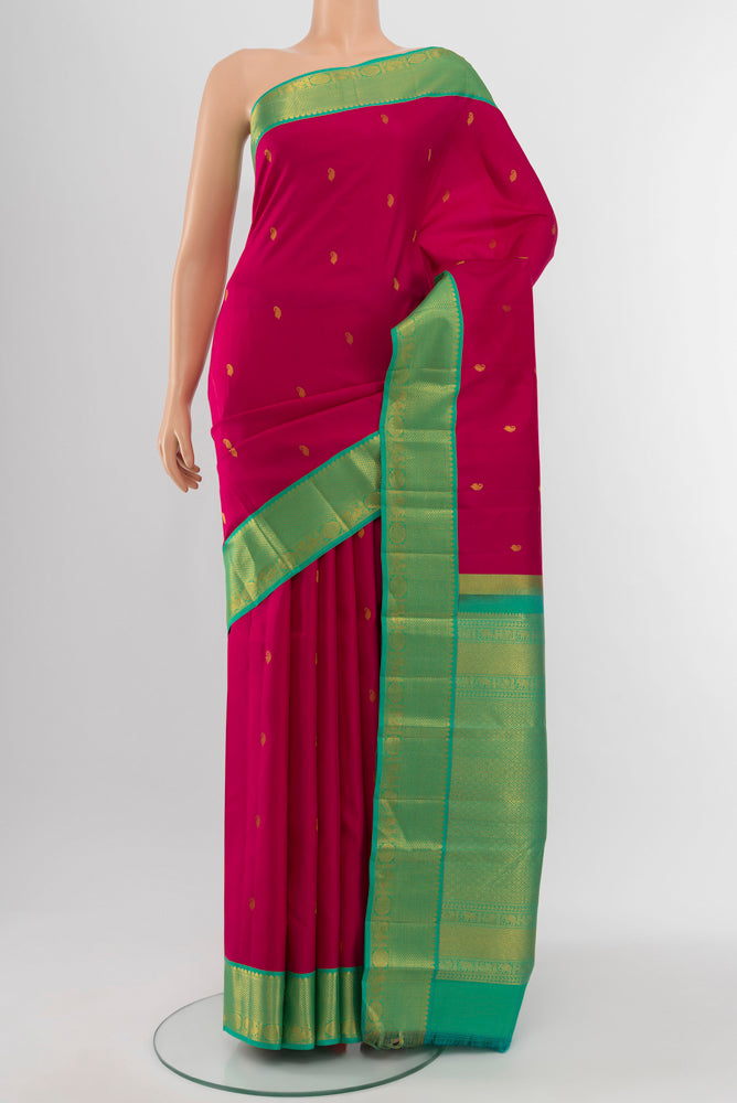Rani Pink Kanchipuram Silk Saree with Zari Butta on the body and Silk Border.  displayed on a mannequin
