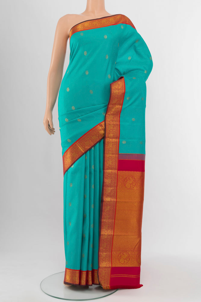 Light Blue Kanchipuram Silk Saree with Zari Butta on the body and Silk Border.  displayed on a mannequin