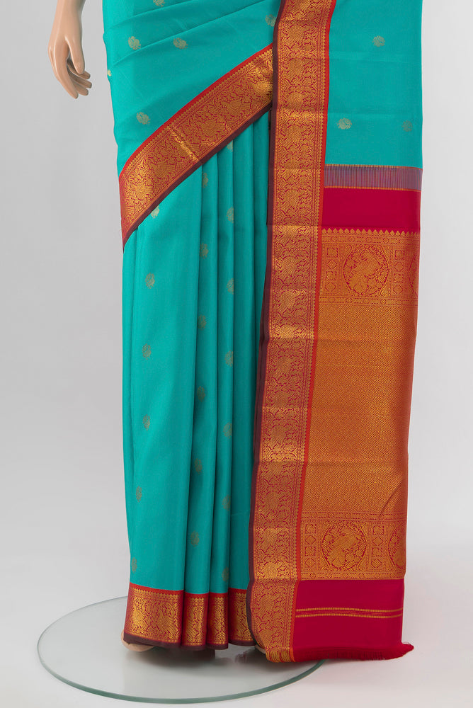 Pleats and pallu of Light Blue Kanchipuram Silk Saree with Zari Butta on the body and Silk Border. 
