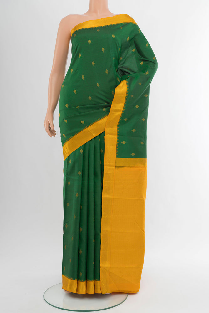 Pure Silk Pure Zari Mint Green Kanchipuram Saree with Zari Butta on the body and Silk Border.  displayed on a mannequin