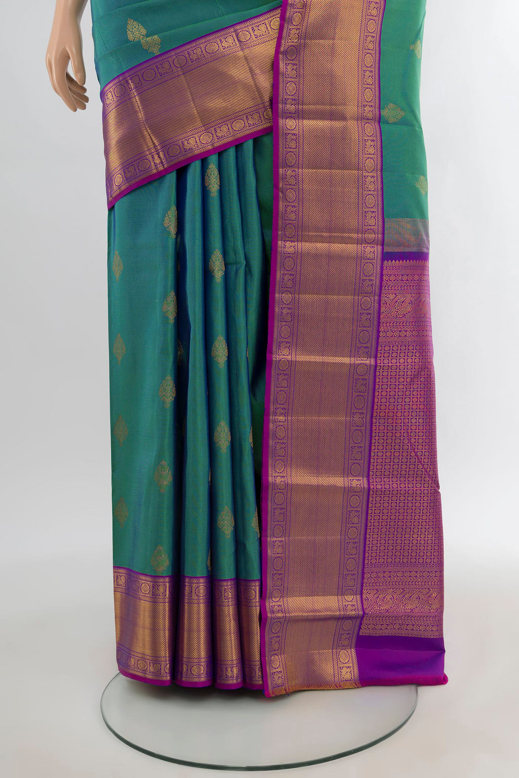 Pleats and pallu of Peacock Blue Kanchipuram Silk Saree with Zari Butta on the body and Zari Border. 