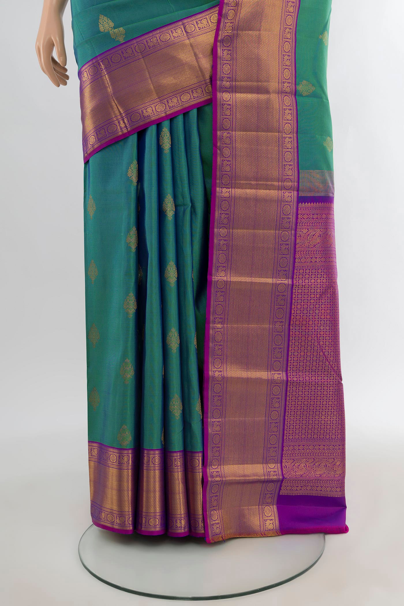 Pleats and pallu of Peacock Blue Kanchipuram Silk Saree with Zari Butta on the body and Zari Border. 