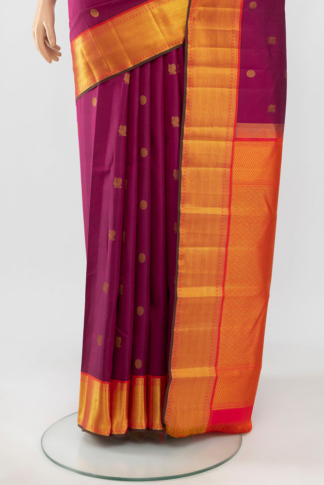 Pleats and pallu of Magenta Kanchipuram Silk Saree with Zari Butta on the body and Silk Border. 