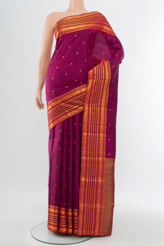Purple Kanchipuram Silk Saree with Zari Butta on the body and Silk Border.  displayed on a mannequin