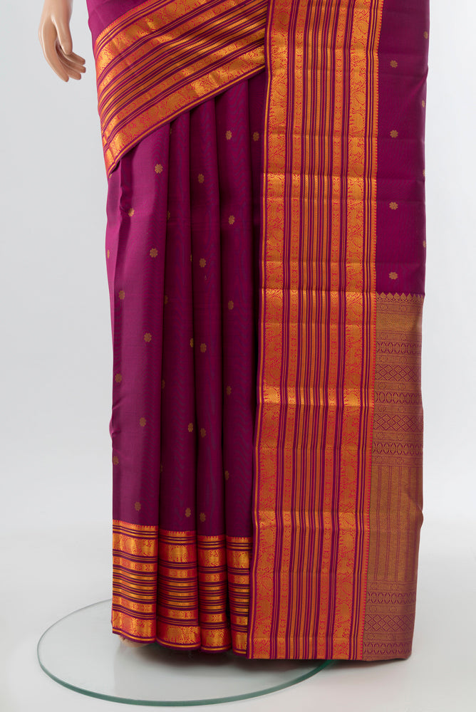 Pleats and pallu of Purple Kanchipuram Silk Saree with Zari Butta on the body and Silk Border. 