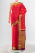 Pure Silk Pure Zari Peach Kanjivaram Saree with Zari Butta on the body and Silk Border.  displayed on a mannequin
