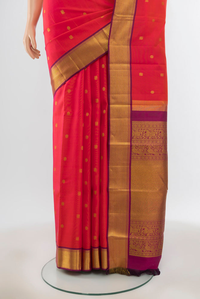 Pleats and pallu of Pure Silk Pure Zari Peach Kanjivaram Saree with Zari Butta on the body and Silk Border. 