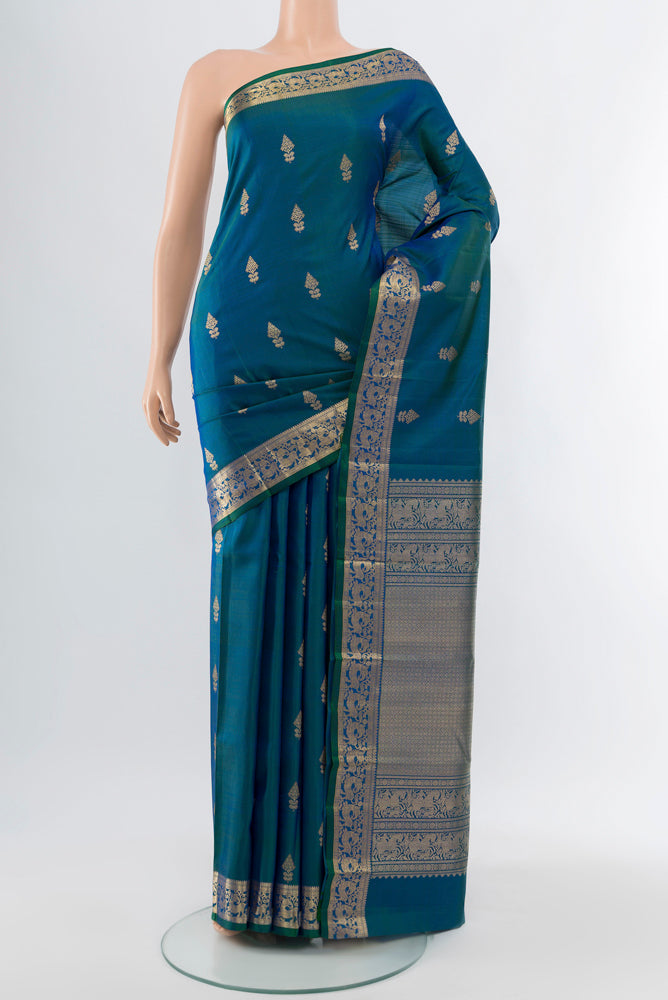 Peacock Blue Kanjivaram Silk Saree with Zari Butta on the body and Silk Border.  displayed on a mannequin
