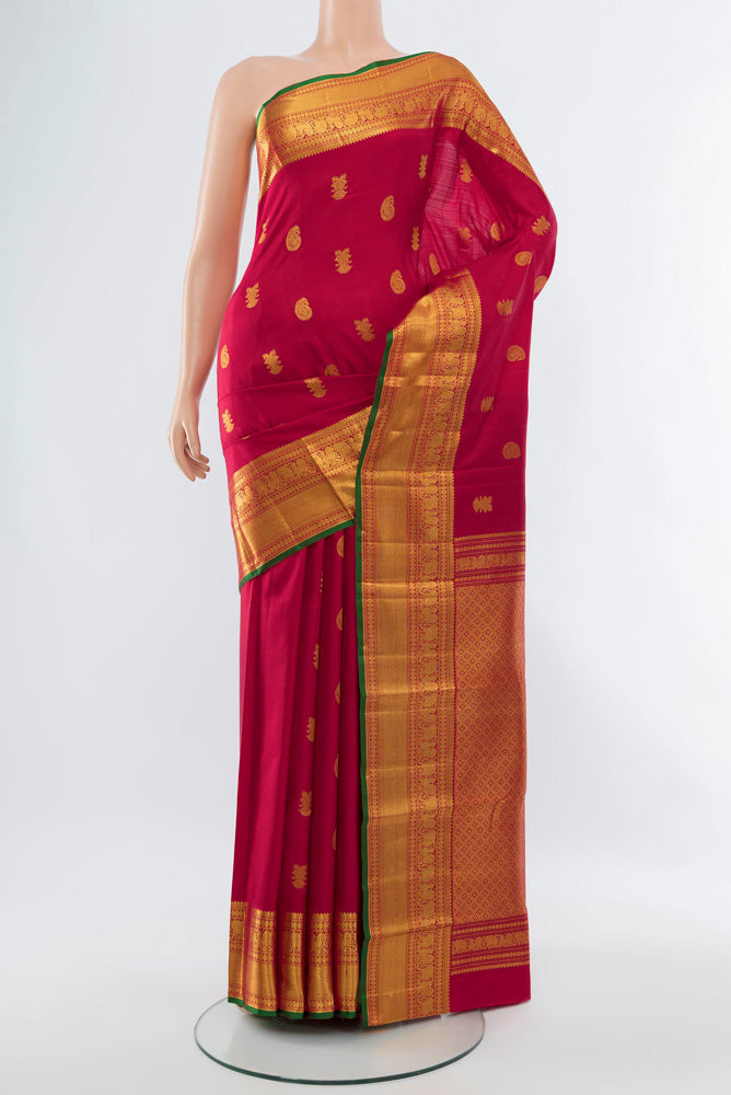 Dark Pink Kanjivaram Silk Saree with Zari Butta on the body and Silk Border.  displayed on a mannequin
