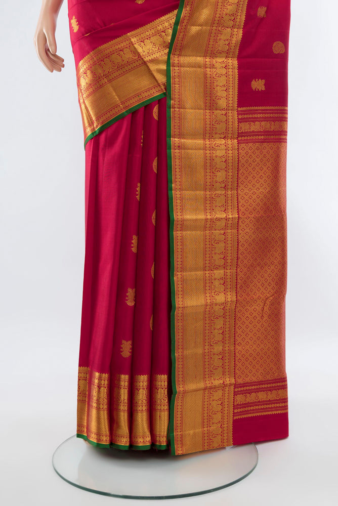 Pleats and pallu of Dark Pink Kanjivaram Silk Saree with Zari Butta on the body and Silk Border. 