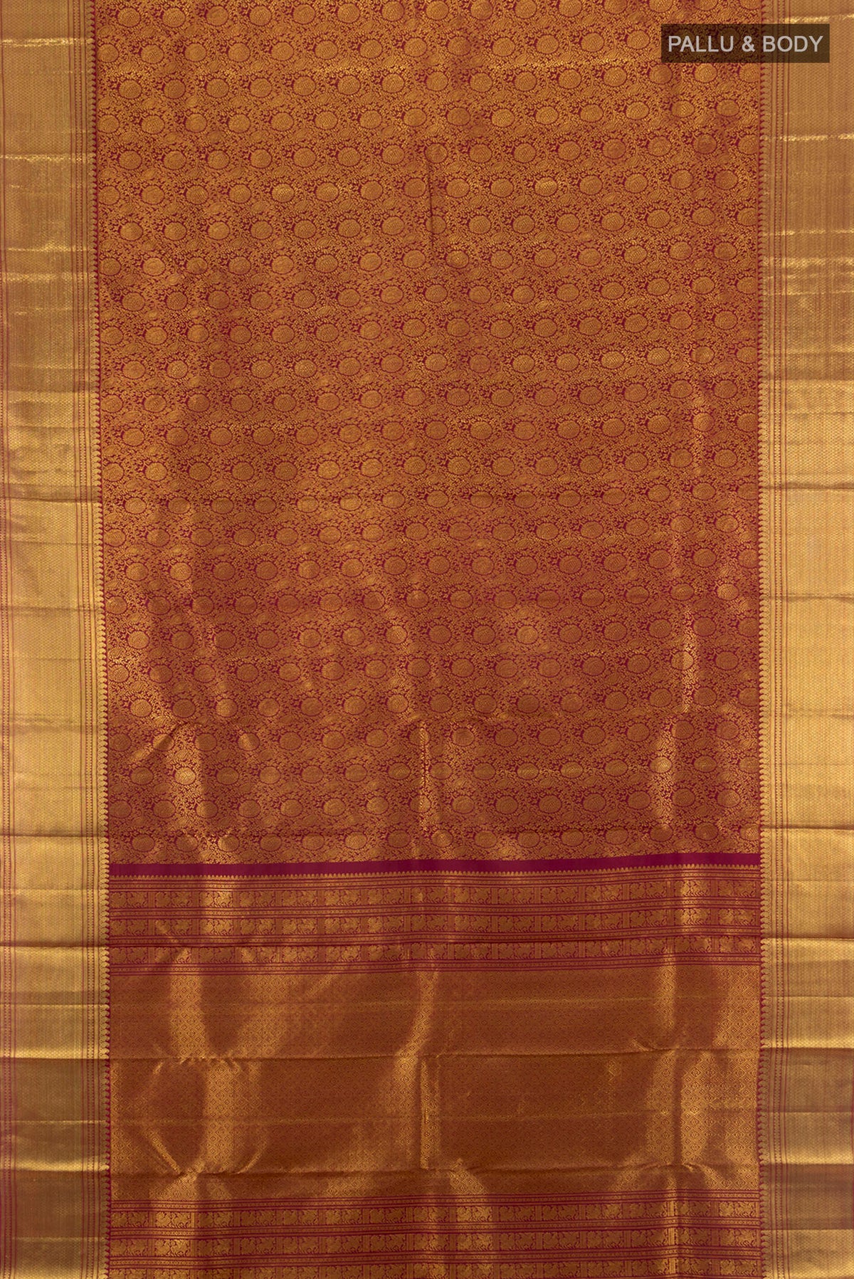 Flat view of Maroon Kanchipuram Silk Saree with Zari Butta on the body and Silk Border. 