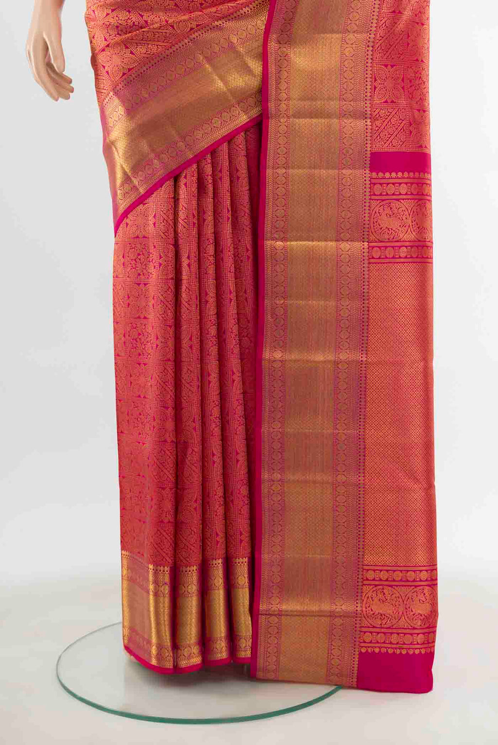 Pleats and pallu of Rani Pink Kanchipuram Silk Saree with Zari Butta on the body and Silk Border