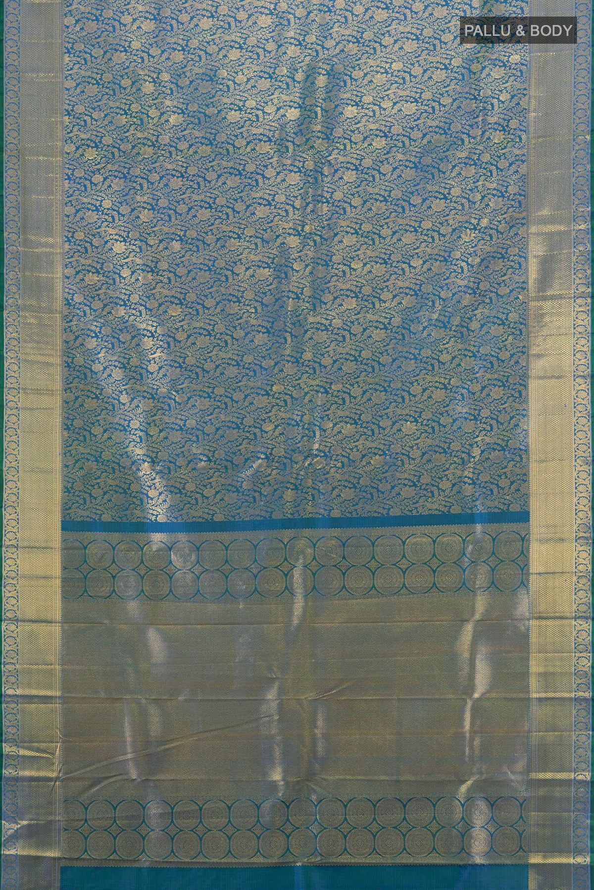 Flat view of Peacock Blue Kanchipuram Silk Saree with Zari Brocade on the body and Zari Border. 