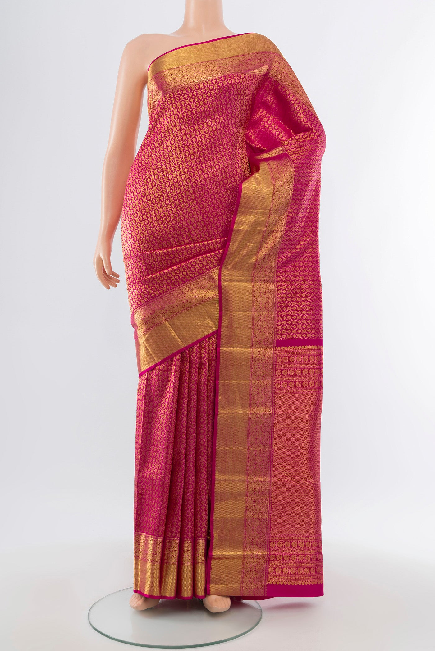 Pure Silk Pure Zari Magenta Kanchipuram Saree with Zari Butta on the body and Silk Border.  displayed on a mannequin