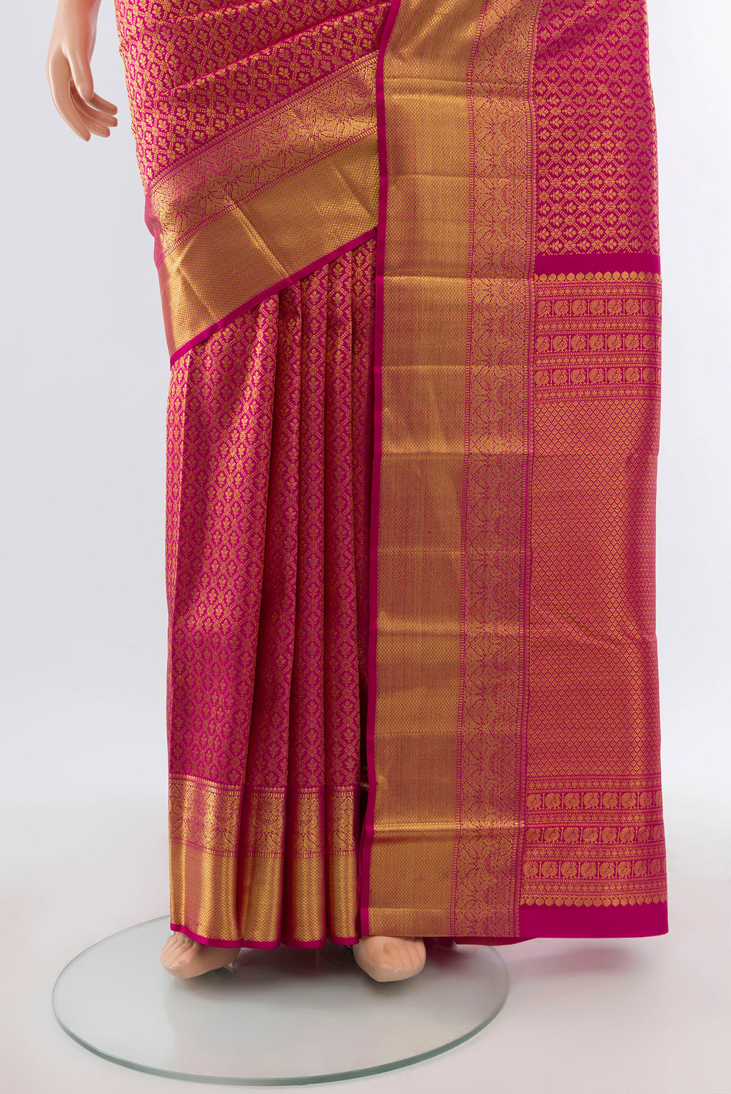 Pleats and pallu of Pure Silk Pure Zari Magenta Kanchipuram Saree with Zari Butta on the body and Silk Border. 