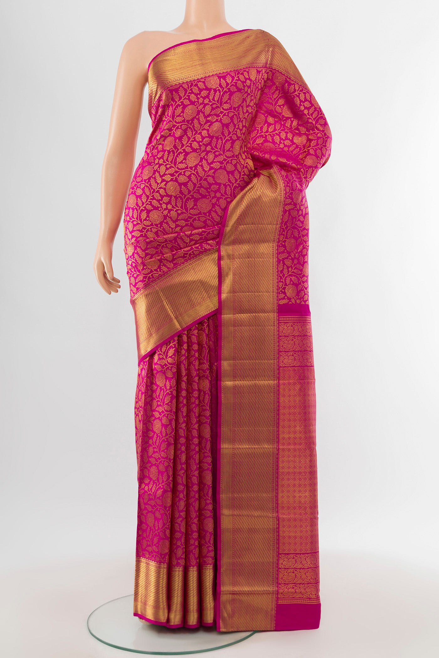 Pure Silk Pure Zari Magenta Kanchipuram Saree with Zari Butta on the body and Silk Border.  displayed on a mannequin