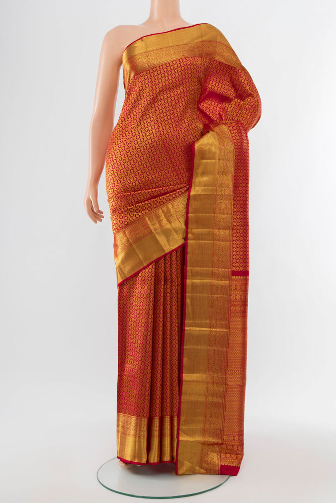 Golden Kanchipuram Silk Saree with Zari Butta on the body and Silk Border.  displayed on a mannequin
