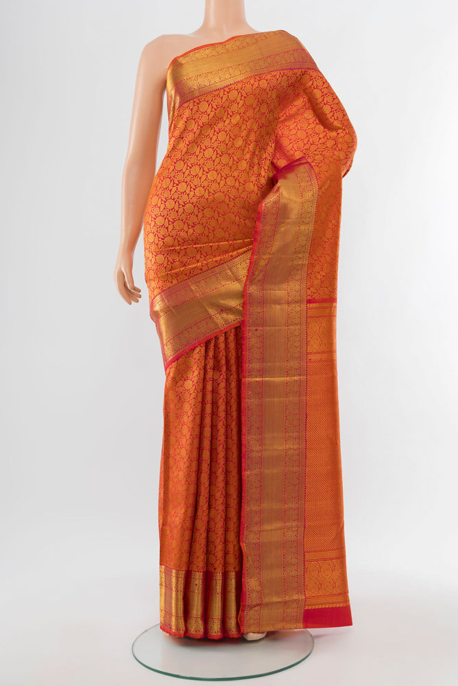 Golden Peach Kanchipuram Silk Saree with Zari Butta on the body and Silk Border.  displayed on a mannequin