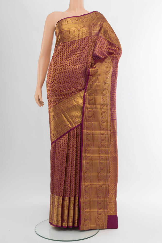 Pure Silk Pure Zari Light Magenta Kanchipuram Saree with Zari Butta on the body and Silk Border.  displayed on a mannequin
