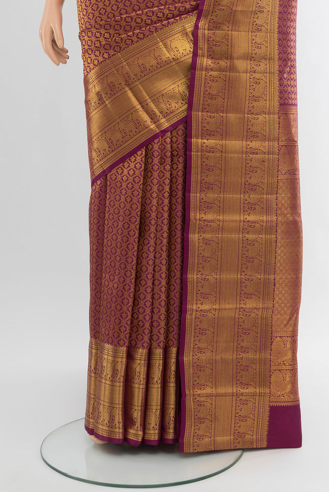 Pleats and pallu of Pure Silk Pure Zari Light Magenta Kanchipuram Saree with Zari Butta on the body and Silk Border. 