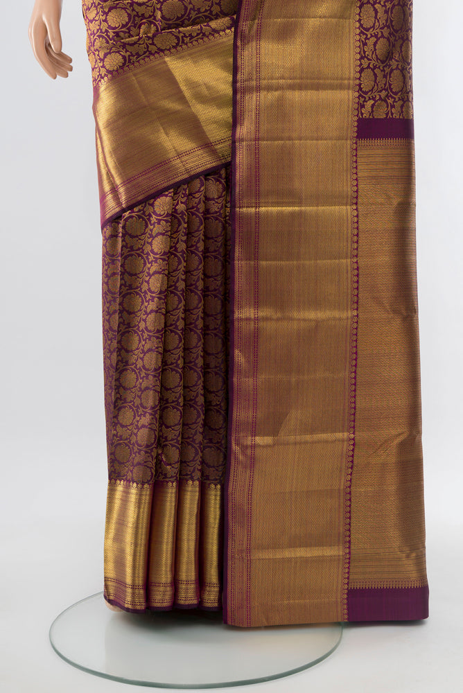 Pleats and pallu of Purple Kanchipuram Silk Saree with Zari Butta on the body and Silk Border. 