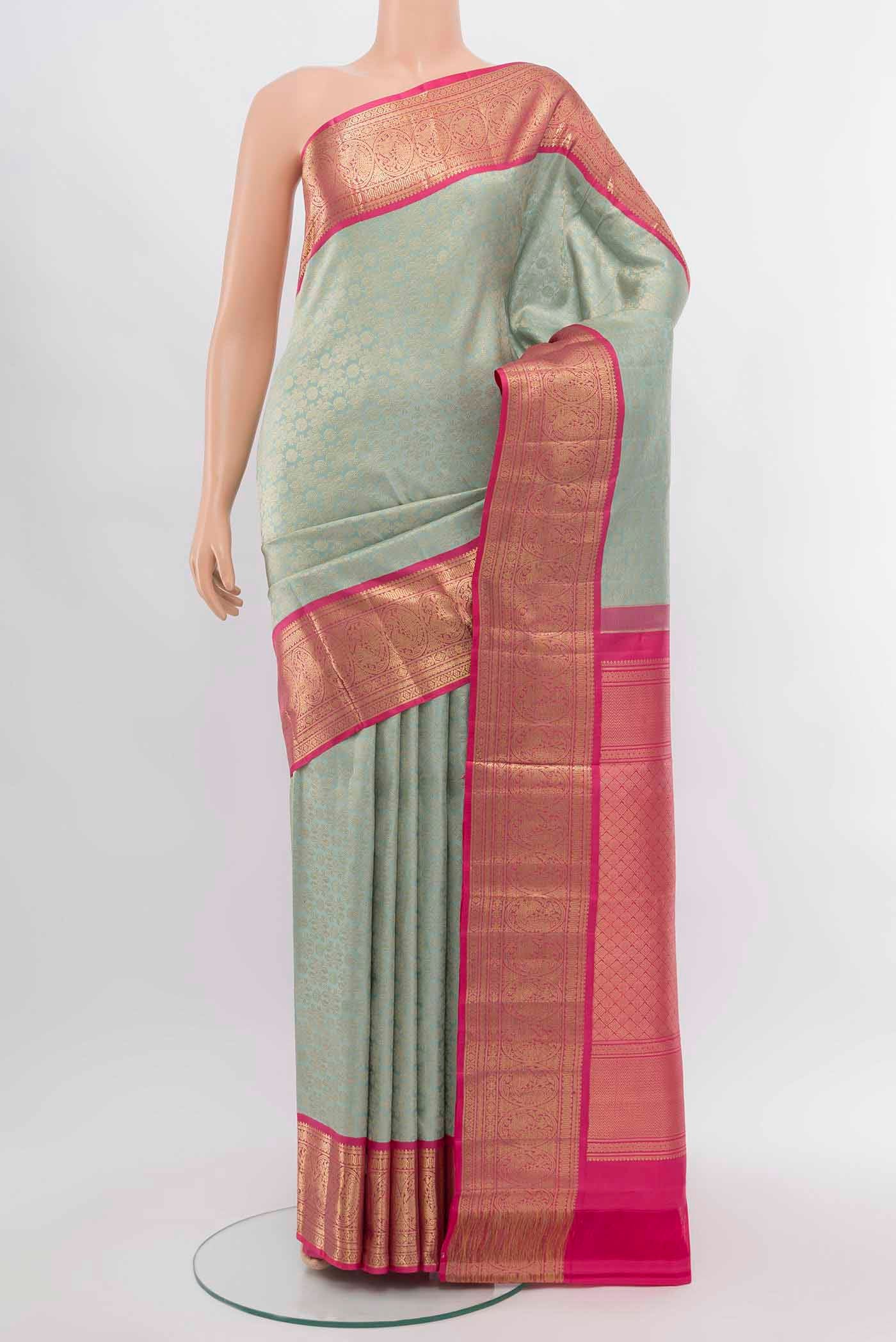Sky Blue Kanchipuram Silk Saree with Zari Butta on the body and Silk Border.  displayed on a mannequin