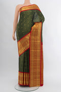 Bottle Green Kanjivaram Silk Saree with Zari Butta on the body and Silk Border.  displayed on a mannequin