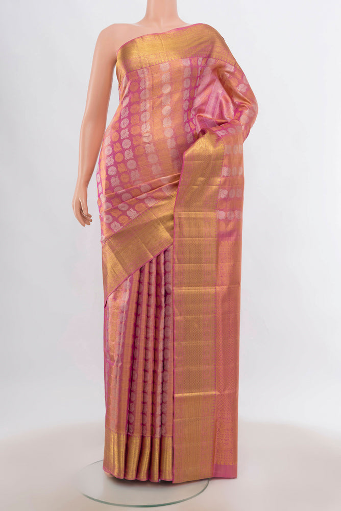 Peach Kanjivaram Silk Saree with Zari Butta on the body and Silk Border.  displayed on a mannequin