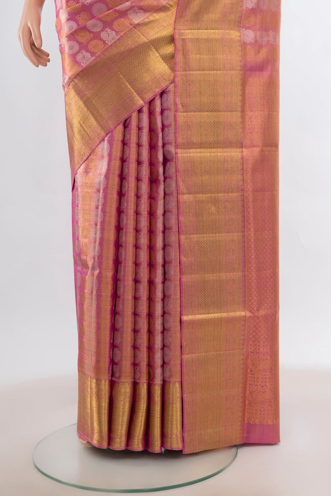 Pleats and pallu of Peach Kanjivaram Silk Saree with Zari Butta on the body and Silk Border. 