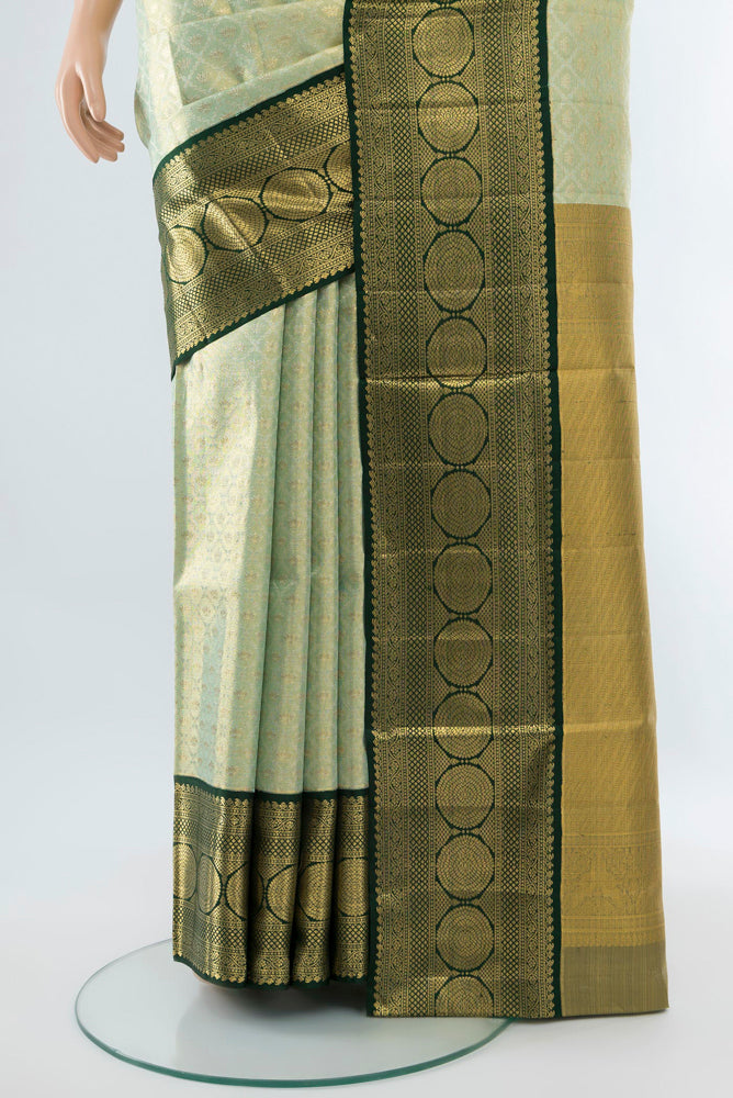 Pleats and pallu of Pista Green Kanjivaram Silk Saree with Zari Butta on the body and Silk Border. 