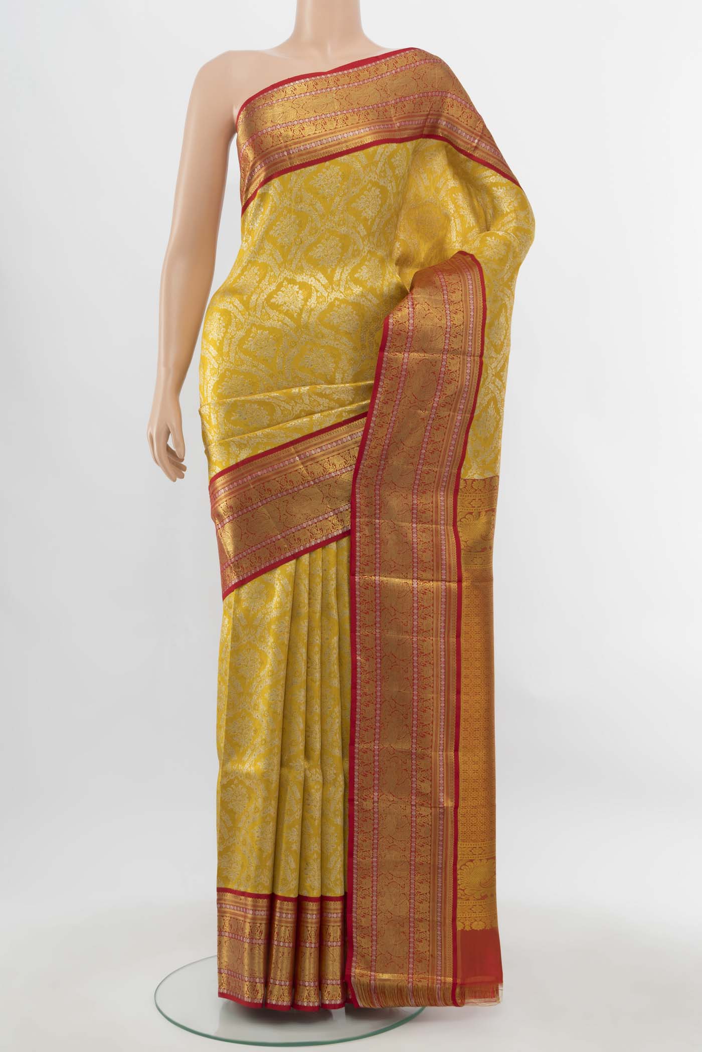 Pure Silk Pure Zari Golden Kanjivaram Saree with Zari Butta on the body and Silk Border.  displayed on a mannequin