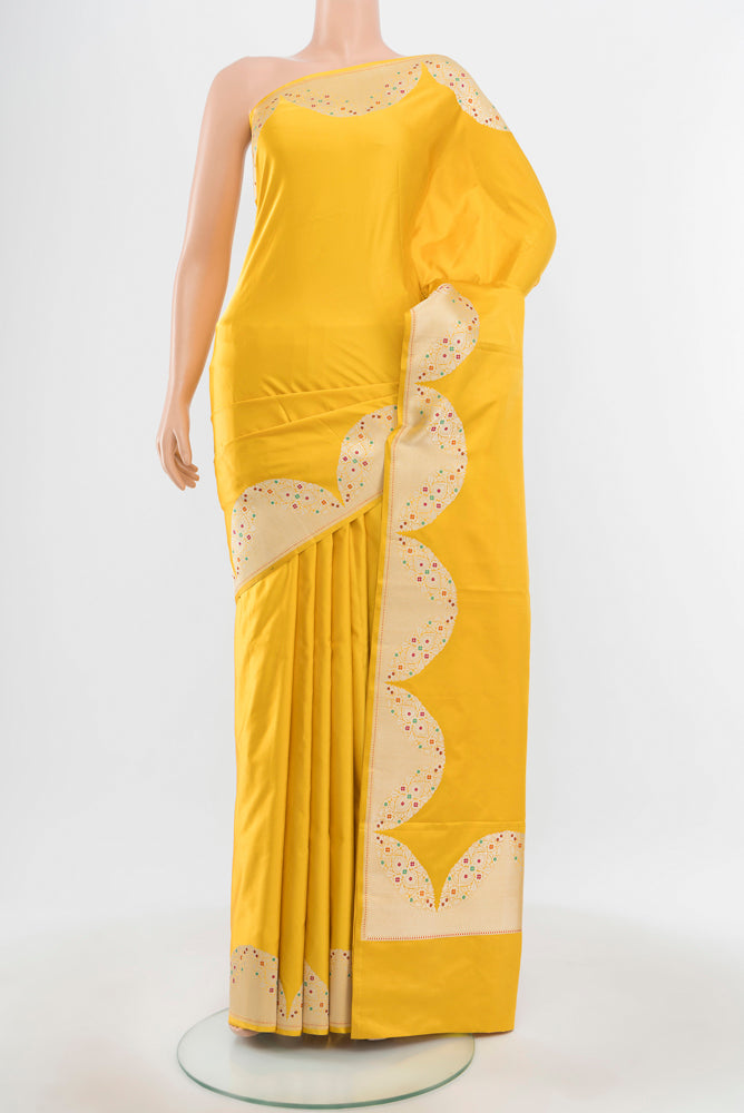 Pure Silk Pure Zari Lemon Yellow Banarasi Saree with Zari Butta on the body and Silk Border.  displayed on a mannequin